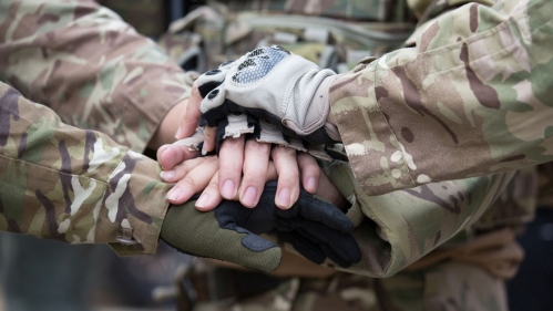 comforting image of hands crossed illustrates Vets4Warriors mission of support veterans