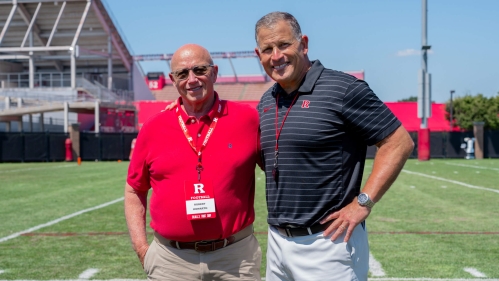 Dentist W. Robert Howarth RC’70, GSNB’75, left, with Scarlet Knights football Coach Greg Schiano.